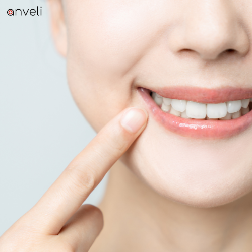 A woman smiling after experiencing no dental implant pain.